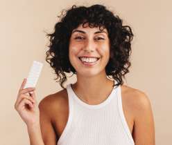 A girl holing birth control medicine