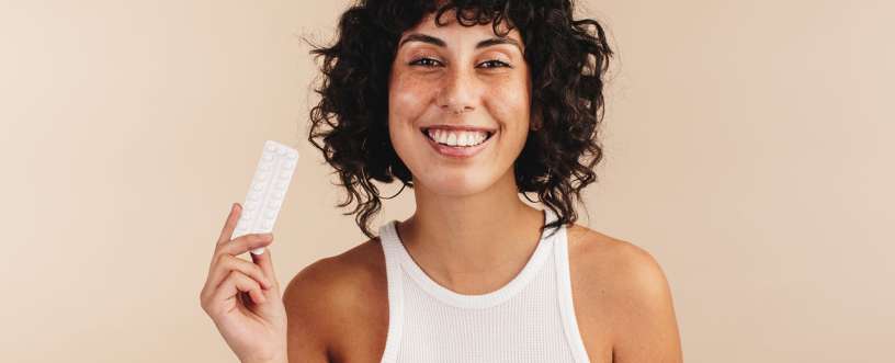 A girl holing birth control medicine