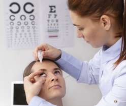 Doctor adding eye drop to patient