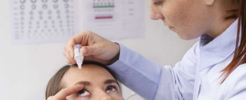 Doctor adding eye drop to patient