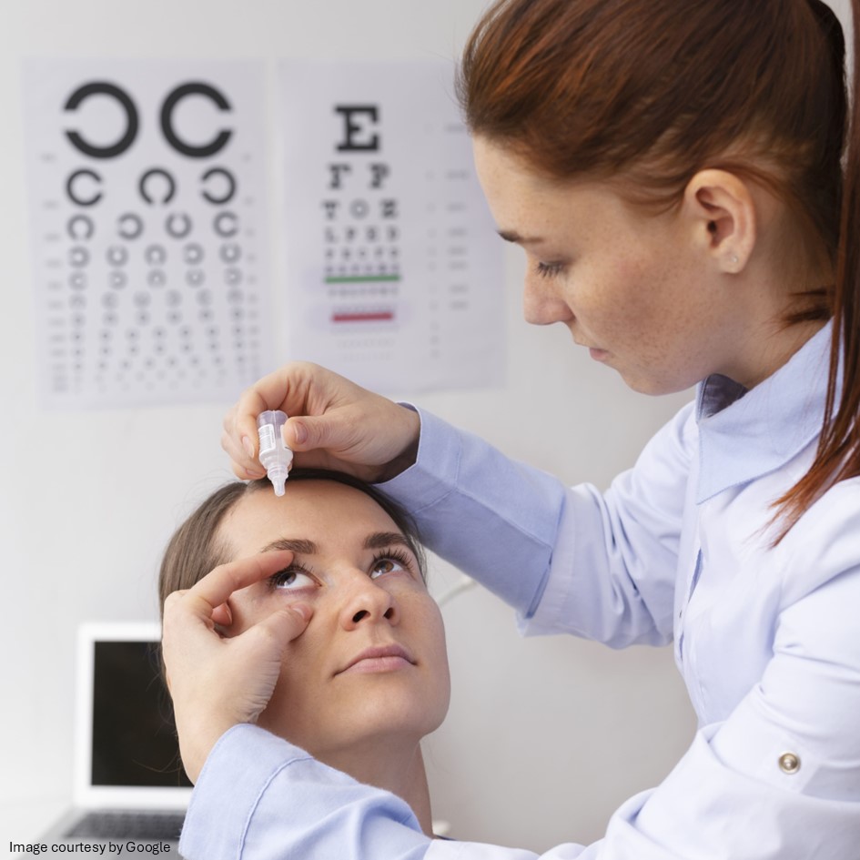 Doctor adding eye drop to patient