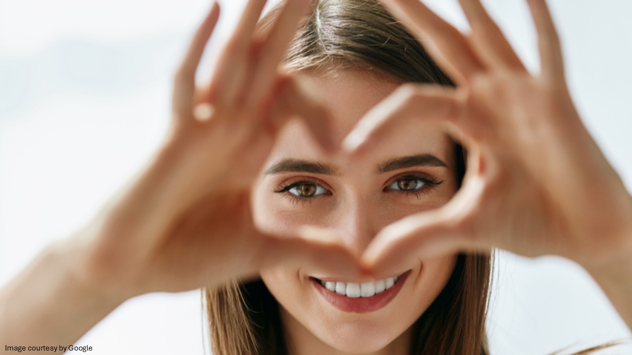 A girl making heart shape by hands