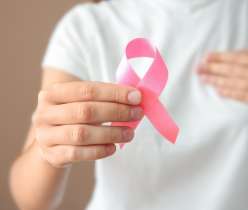 A hand holding cancer sign