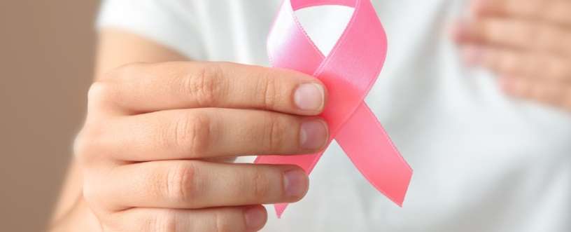 A hand holding cancer sign