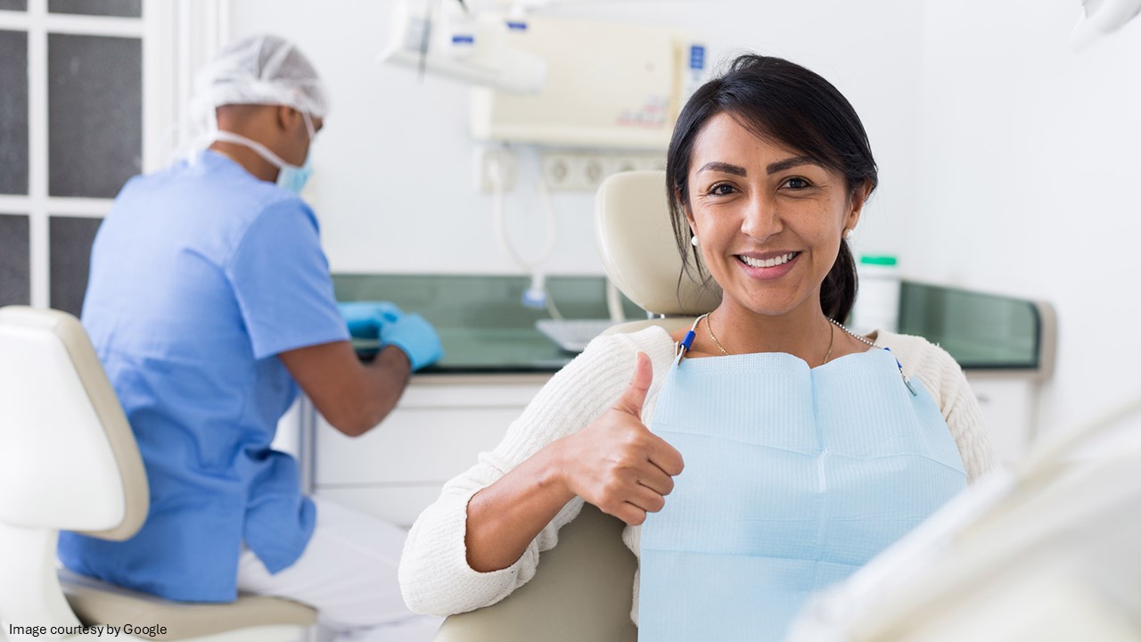 A lady showing thumbs up and a doctor in background