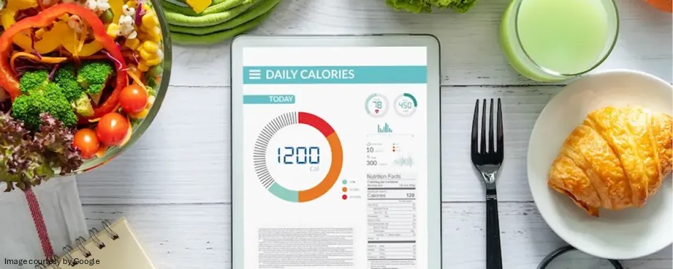 Tablet displaying daily calorie tracking dashboard with healthy meal