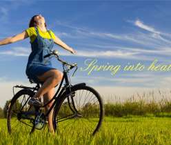 A girl on a bicycle with open hand in spring season