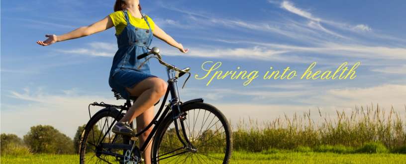 A girl on a bicycle with open hand in spring season