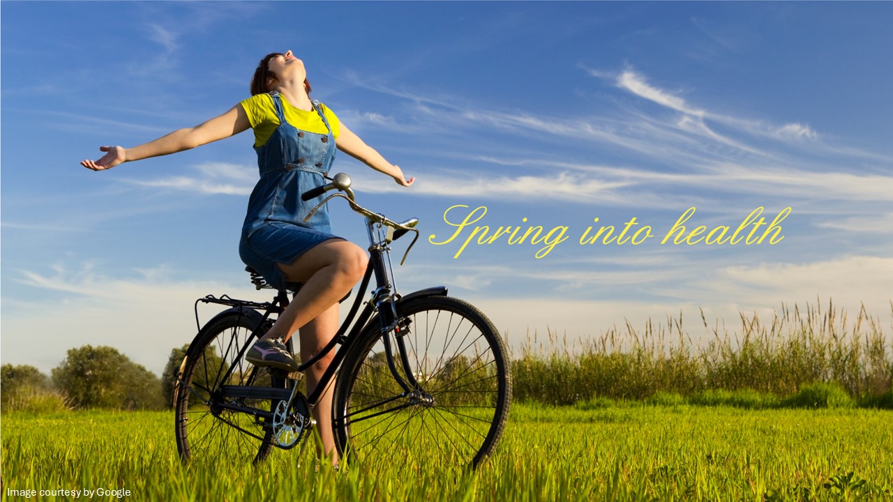A girl on a bicycle with open hand in spring season