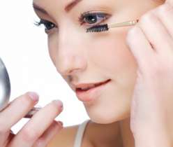 women applying eyelash serum