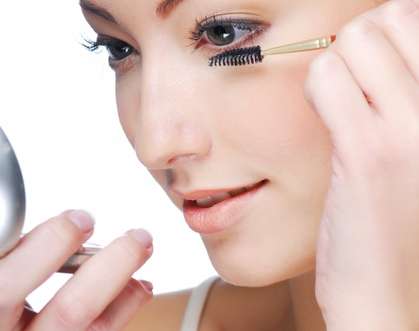 women applying eyelash serum