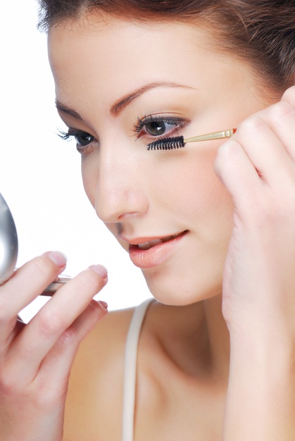 women applying eyelash serum