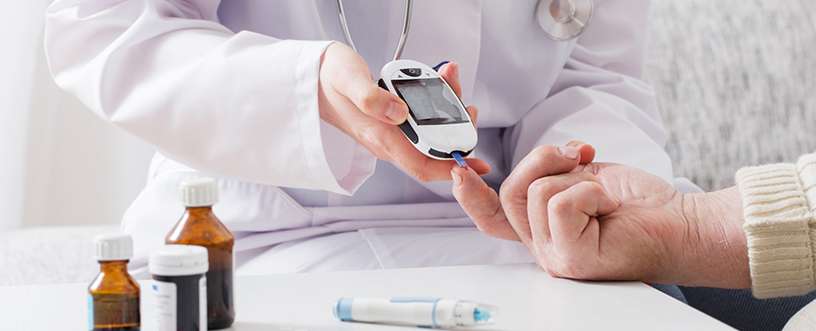 Doctor checking patient's blood sugar levels using a glucometer alongside diabetes medications, emphasizing safe management through medical care and treatment.