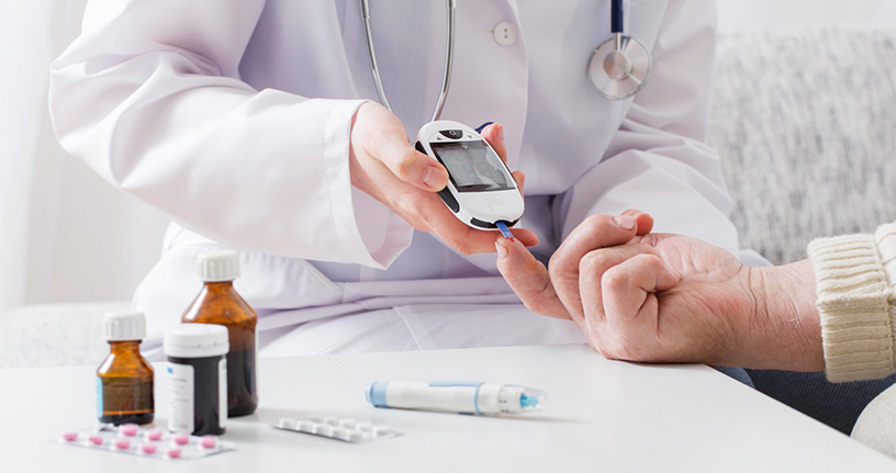 Doctor checking patient's blood sugar levels using a glucometer alongside diabetes medications, emphasizing safe management through medical care and treatment.