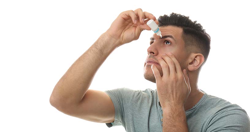 Man applying eye drops symbolizing Careprost eyelash serum use; compare best eyelash growth serums like Latisse vs Careprost.