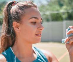 Girl holding asthma inhaler