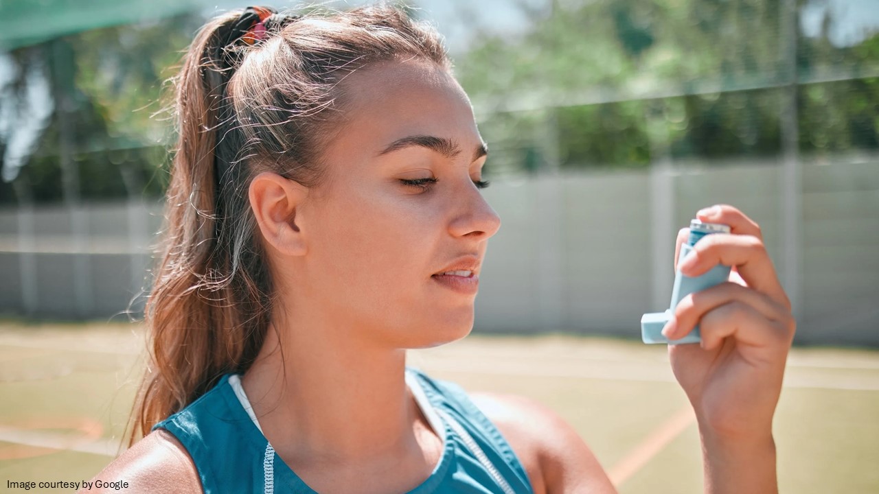Girl holding asthma inhaler