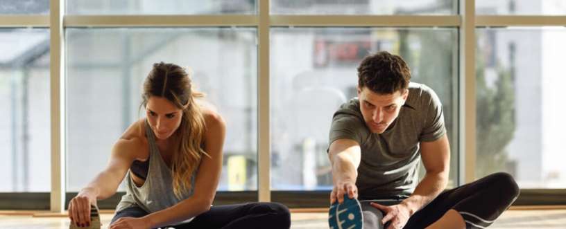 Two people doing stretching exercise