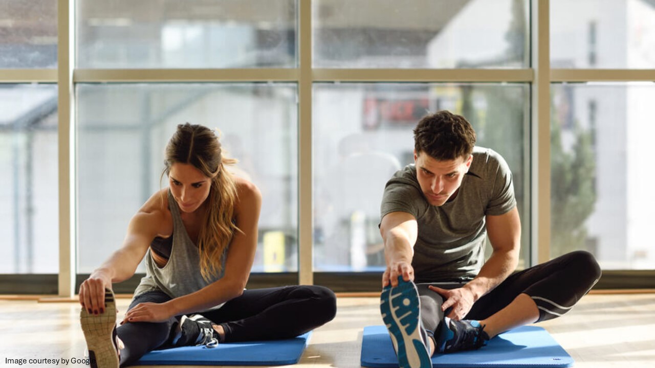 Two people doing stretching exercise