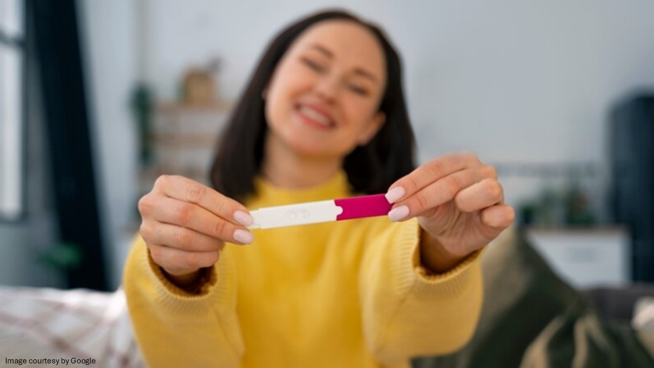 Lady holding a pregnancy strip