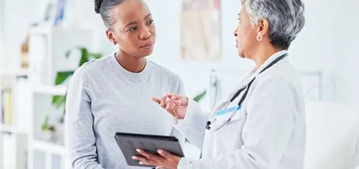 doctor consulting patient suffering from acidity