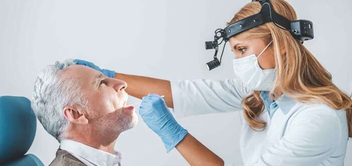 doctor checking for oral cancer