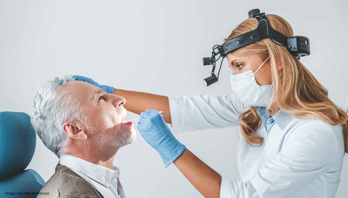 doctor checking for oral cancer