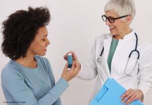 doctor giving inhaler to patient
